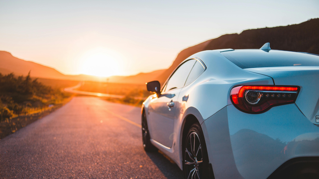 car driving in hot summer sun highlighting need for paint protection from heat and UV damage